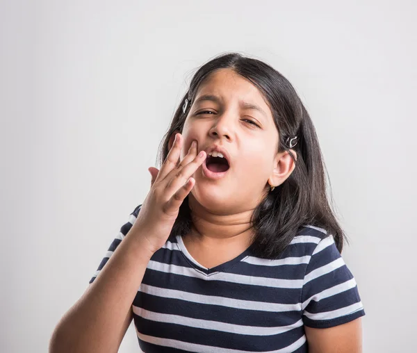 Indian small girl and toothache, sad indian little girl with tooth pain, stressful indian girl with paining tooth, indian girl suffering from toothache, indian girl with dental problem