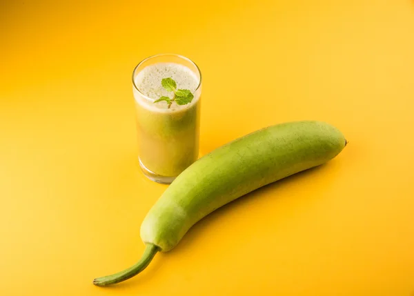 Juice of bottle gourd or lauki juice or Lagenaria siceraria juice, bottle gourd juice, powerful health juice popular in India, isolated over white background