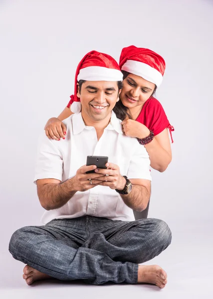 Indian young couple taking selfie on christmas, christmas and selfie, india and christmas, indian and red christmas hat, mobile selfie and india, young asian couple and selfie on christmas day