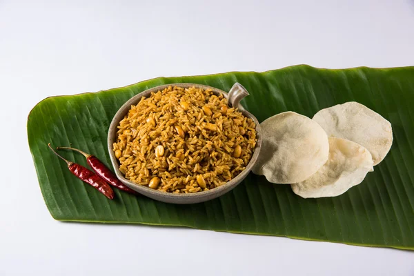 Tamarind Rice or puliyodharai rice and Poppadom from Tamil Nadu, India