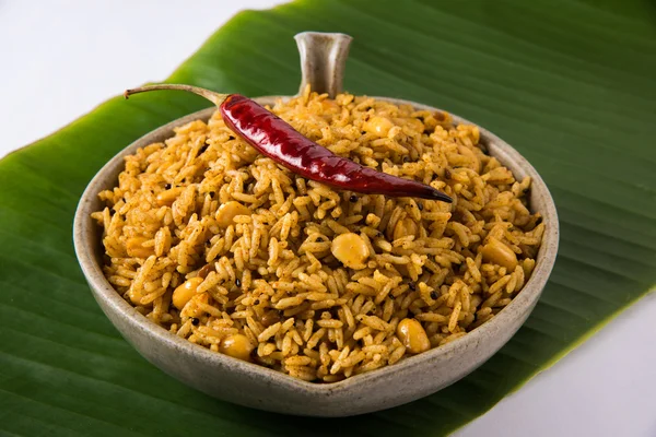 Tamarind Rice or puliyodharai rice and Poppadom from Tamil Nadu, India