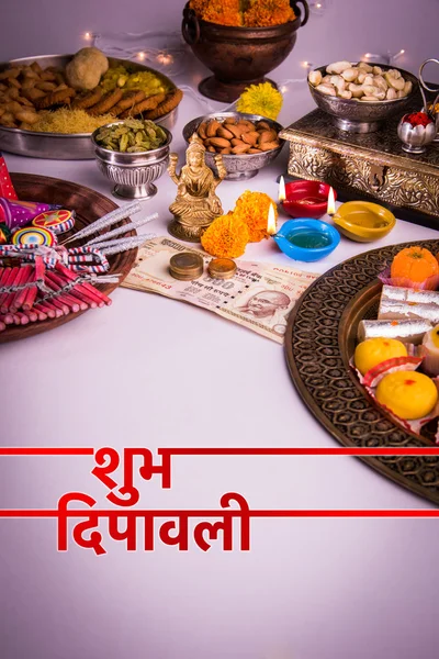 Happy Diwali Greeting card showing oil lamp or diya with crackers, sweet or mithai, dry fruits, indian currency notes, marigold flower and statue of Goddess Laxmi or Lakshmi on diwali night