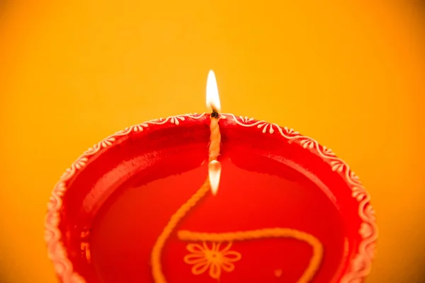 Single Clay diya lamp lit during diwali festival. happy diwali Greetings Card Design, Indian Hindu Festival of lights called Diwali