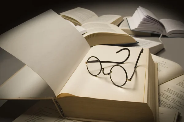 Pair of reading glasses on top of an open book