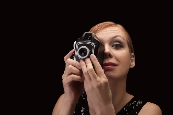 Young woman holding a retro camera