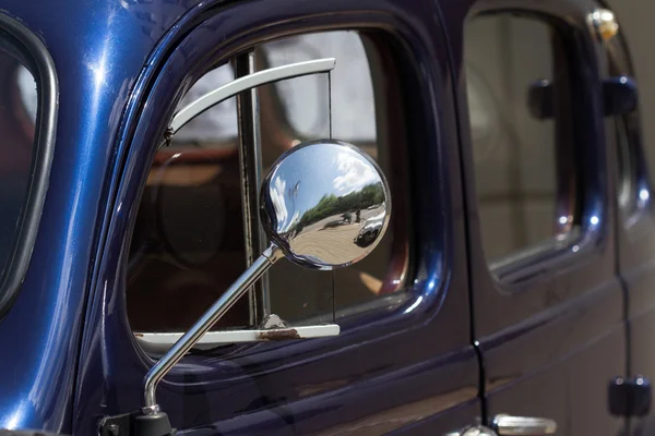 Close up of the mirror of an old car