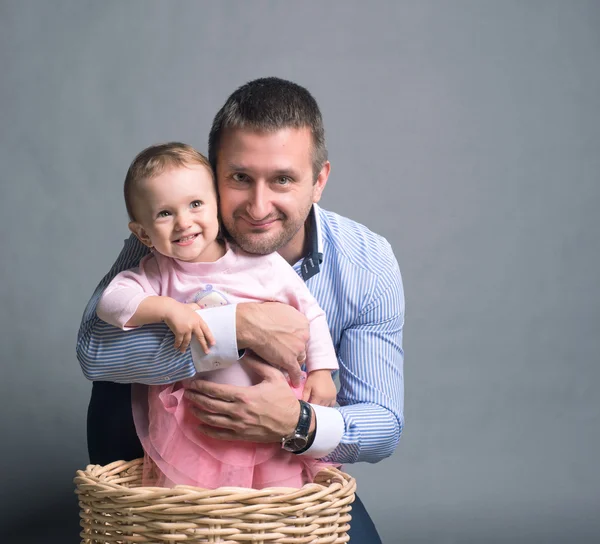 Dad hugs her baby daughter