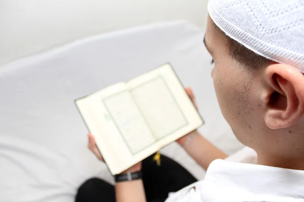 Muslim man Reading Holy Islamic Book Koran