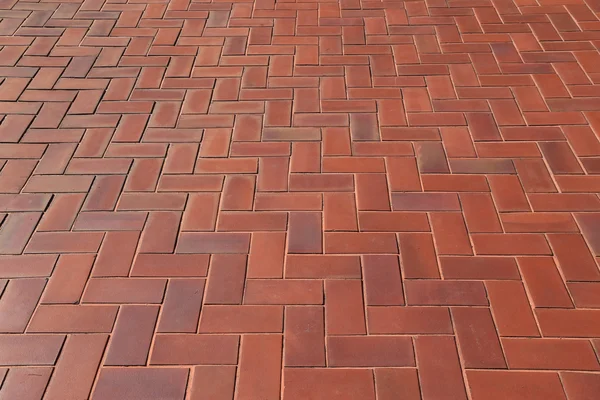 Diagonal pattern of brick pavers in a Herringbone style for back