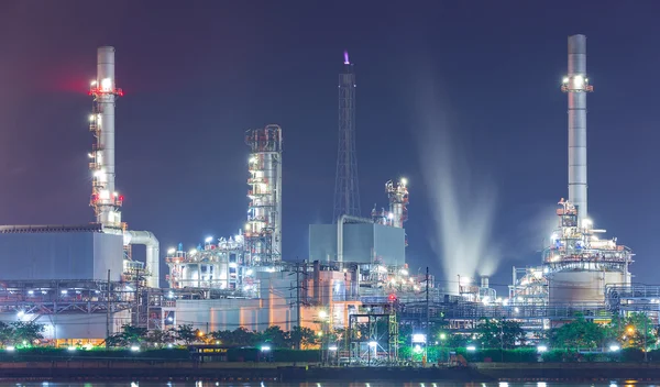 Oil refinery with water vapor, petrochemical industry night scen