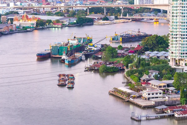 Aerial view of tugboat shipping barges, Bangkok city at Chao Pha