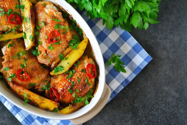 Baked, marinated chicken with potatoes and rosemary