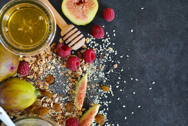 Morning breakfast - granola, honey, berries and fruits. Black co