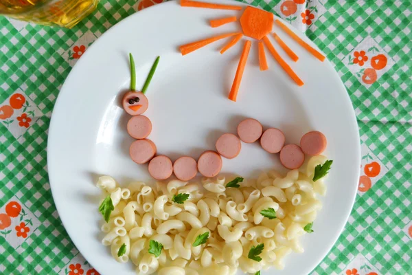 Funny caterpillar of sausages and pasta, dinner for children