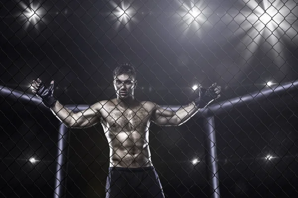 Fighter in mma cage arena