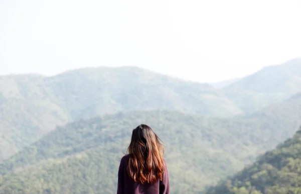 Girl looking at far mountains