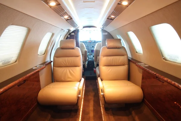 Small business jet cabin - front, cockpit open