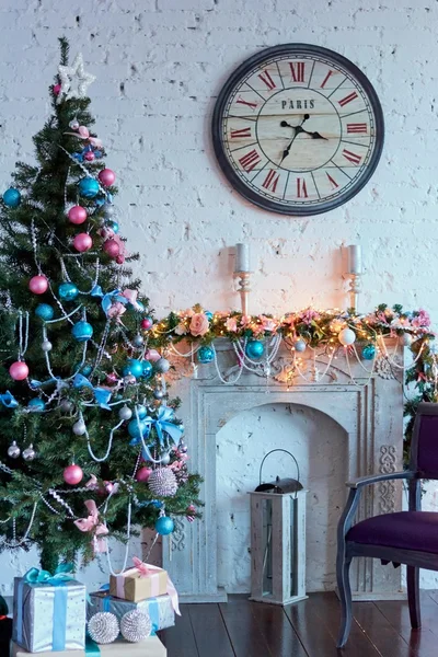 Christmas tree next to fireplace and clock