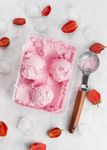 Strawberry ice cream in box on a white background