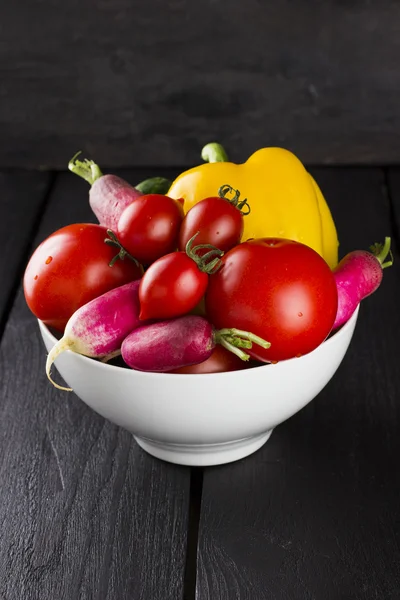 Various vegetables: tomatoes, cherry tomatoes, radish, pepper in