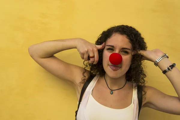 Young woman with clown nose