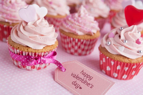 Pink Valentine cupcakes with the words \'Happy Valentine\'s day\'