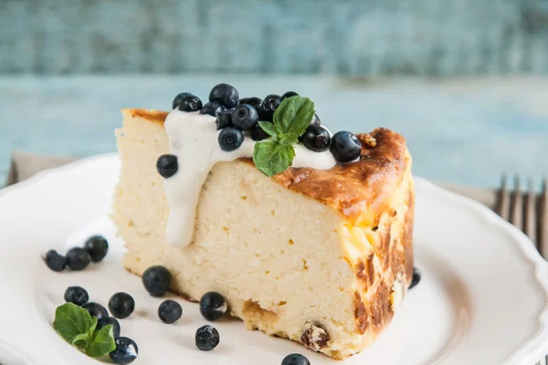 Cottage cheese baked pudding, sour cream and blueberries