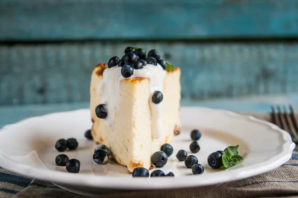 Cottage cheese baked pudding, sour cream and blueberries