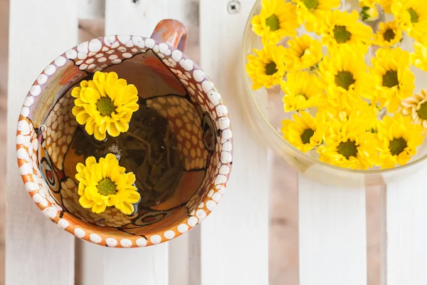 Yellow flowers in a cup of tea