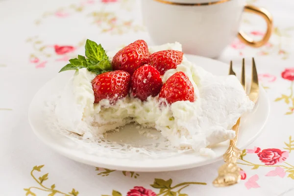 Pavlova cake with strawberries, cup of coffee in romantic style