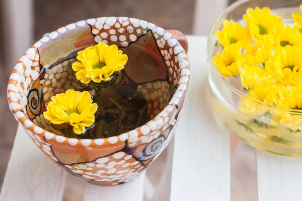 Yellow flowers in a cup of tea