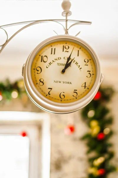 Antique clock on the background of Christmas garlands