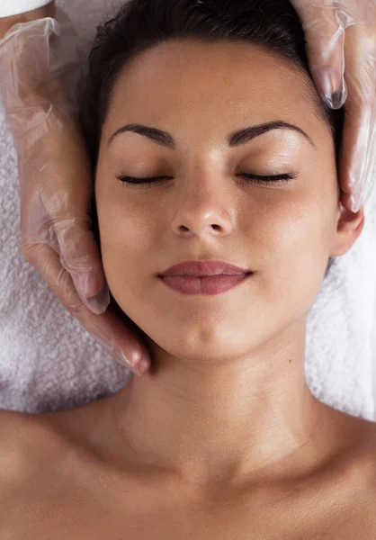 Facial massage. Pretty woman relaxing in the beauty treatment.