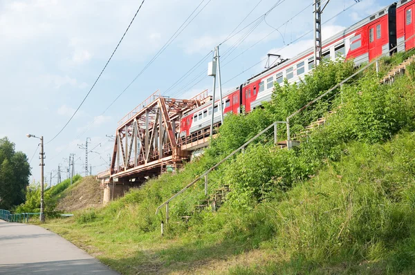 Train on the railway bridge Savelovsky direction through the river Klyazma in town Dolgoprudny