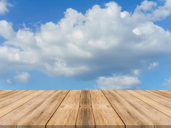 Vintage wooden board empty table in front of sky background. Perspective wood floor over sky - can be used for display or montage your products. beach & summer concepts.
