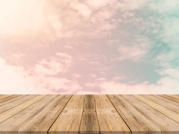 Vintage wooden board empty table in front of sky background. Perspective wood floor over sky - can be used for display or montage your products. Vintage filter.