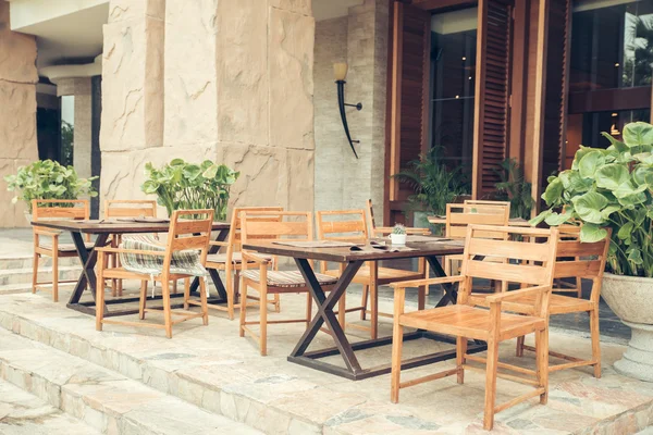 Cafe with tables and chairs in an old street in Europe with retro vintage Instagram style filter effect