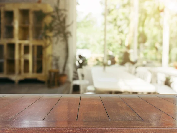 Wooden board empty table in front of blurred background. Perspective brown wood over blur in coffee shop - can be used for display or montage your products.Mock up for display of product.