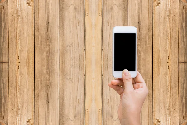 Woman hands with wood wall cell phone, mock up