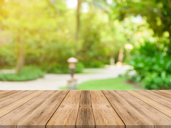 Wooden board empty table in front of blurred background. Perspective brown wood over blur trees in forest - can be used mock up for display or montage your products. spring season. vintage filtered.