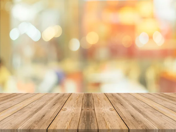 Wooden board empty table in front of blurred background. Perspective brown wood over blur in coffee shop - can be used for display or montage your products.Mock up for display of product.