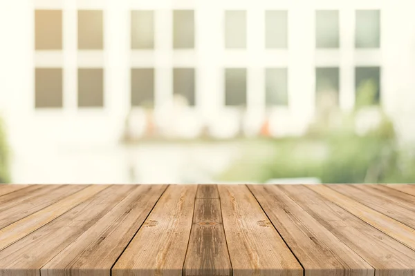 Wooden board empty table in front of blurred background. Perspective brown wood over blur in coffee shop - can be used for display or montage mock up your products. vintage filtered image.
