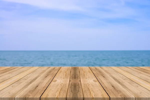 Wooden board empty table in front of blue sea & sky background. Perspective wood floor over sea and sky - can be used for display or montage your products. beach & summer concepts.