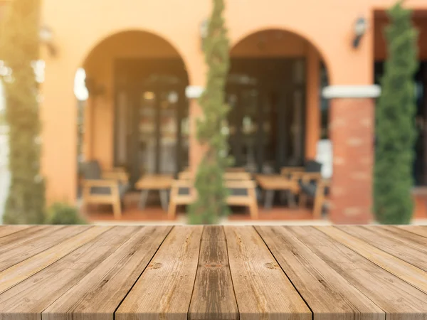 Wooden board empty table in front of blurred background. Perspective brown wood over blur in coffee shop - can be used for display or montage your products.Mock up for display of product.