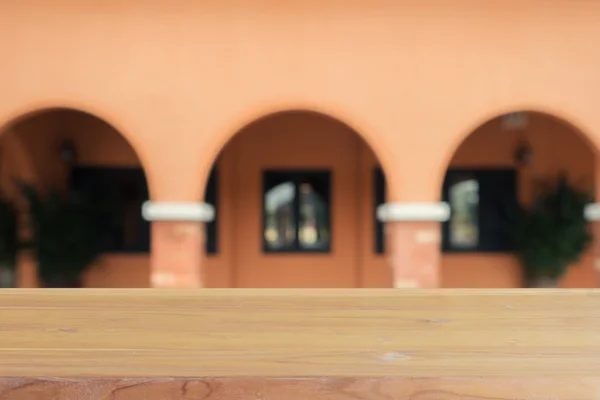 Wooden board empty table in front of blurred background. Perspective brown wood over blur in coffee shop - can be used for display or montage your products.Mock up for display of product.