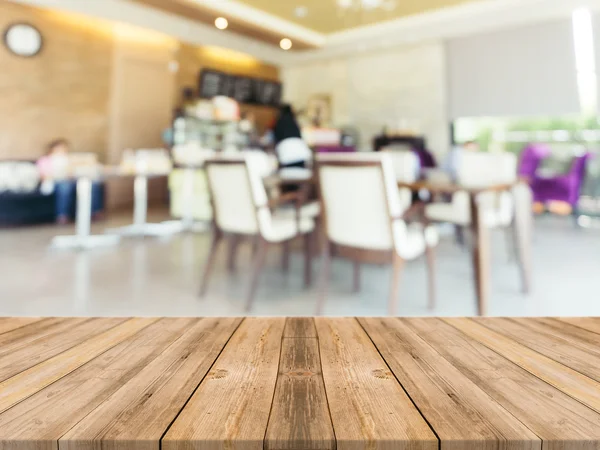 Wooden board empty table in front of blurred background. Perspective brown wood over blur in coffee shop - can be used for display or montage your products.Mock up for display product.