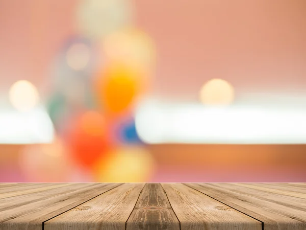 Wooden board empty table blurred background. Perspective brown wood over blur in department store - can be used for display or montage your products.Mock up for display product.