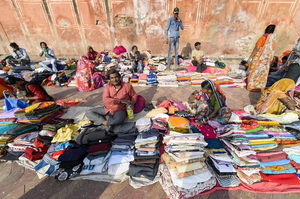 Colourful clothes and saree sell at street market.