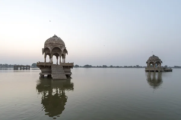 Indian landmarks - Gadi Sagar temple on Gadisar lake during sunrise.