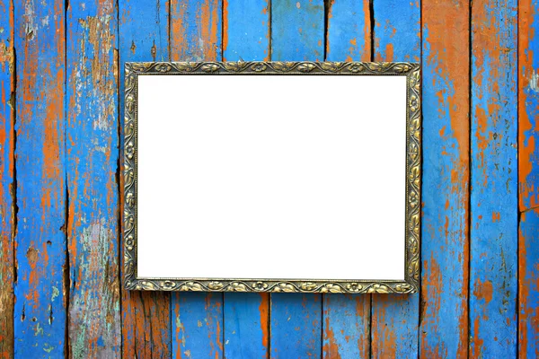 Old wooden picture frame on wooden background.